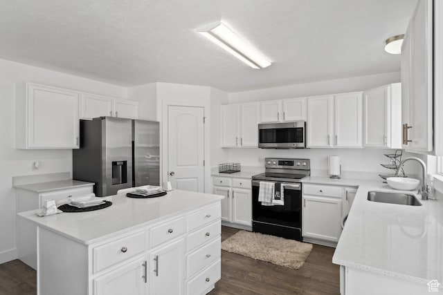 7009 W 7895 S, West Jordan, UT 84081 - kitchen featuring a center island, dark wood finished floors, white cabinets, stainless steel appliances, and a sink