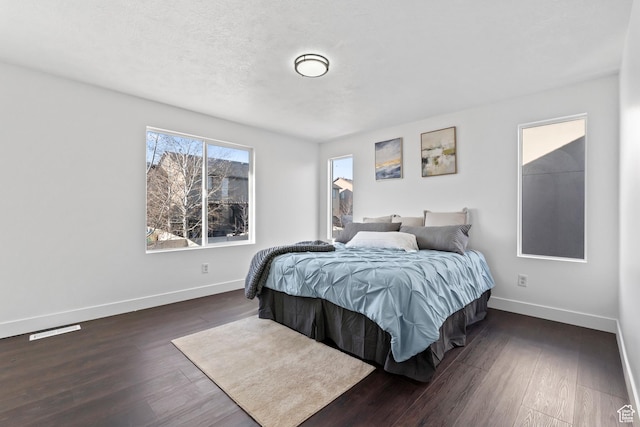 7009 W 7895 S, West Jordan, UT 84081 - bedroom featuring visible vents, a textured ceiling, dark wood-type flooring, and baseboards