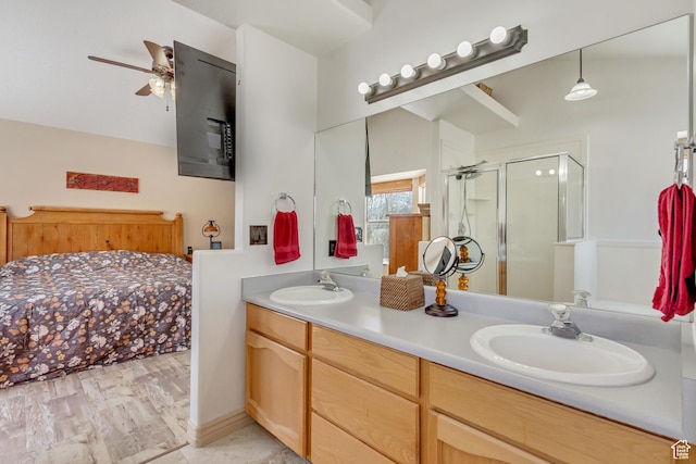bathroom featuring a sink, double vanity, a stall shower, and ceiling fan