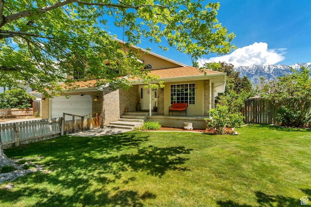 1106 N 600 E, Orem, UT 84097 - view of front of house with an attached garage, a mountain view, and brick siding