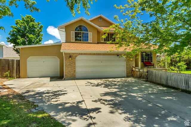 1106 N 600 E, Orem, UT 84097 - traditional-style home with driveway, brick siding, a garage, and stucco siding