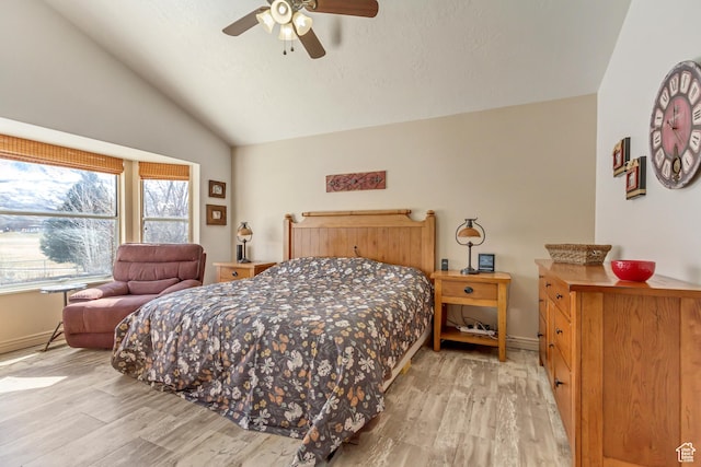 bedroom featuring lofted ceiling, baseboards, and light wood-type flooring