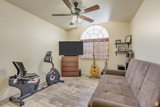interior space featuring vaulted ceiling, baseboards, a ceiling fan, and wood finished floors