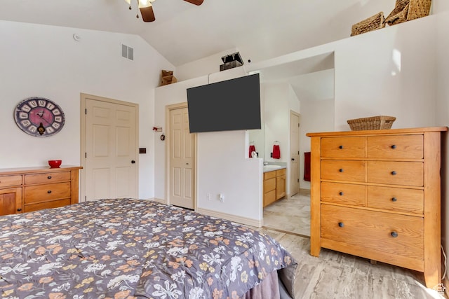 bedroom with a ceiling fan, light wood-style flooring, ensuite bathroom, visible vents, and high vaulted ceiling
