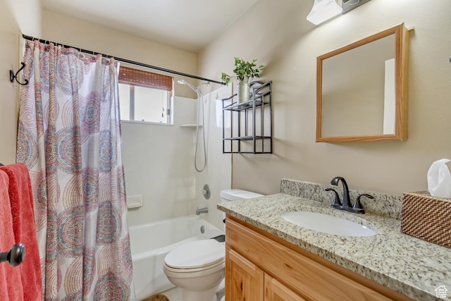 bathroom featuring toilet, shower / bath combo, and vanity