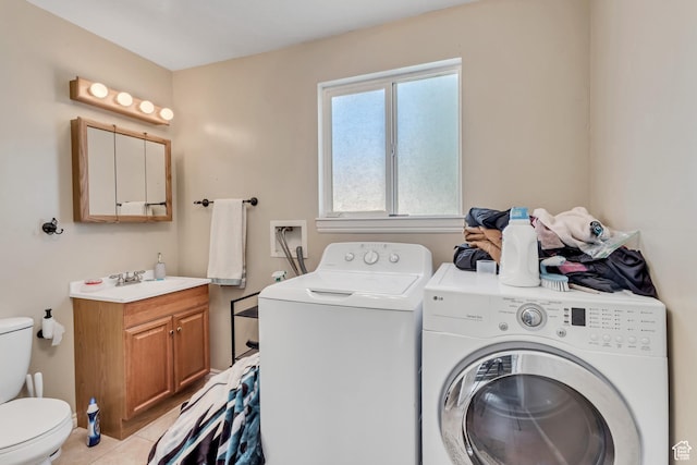 laundry area featuring washer and dryer, laundry area, and light tile patterned floors