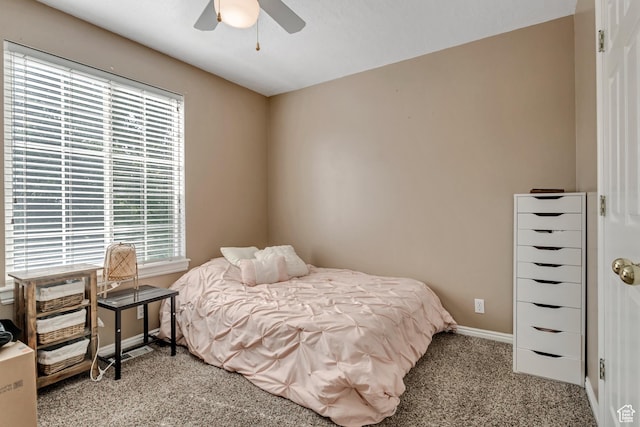 carpeted bedroom featuring a ceiling fan and baseboards