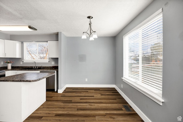1170 N 730 E, Logan, UT 84341 - kitchen featuring dark countertops, visible vents, dark wood-type flooring, stainless steel dishwasher, and a sink