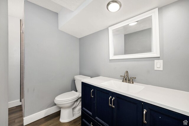1170 N 730 E, Logan, UT 84341 - bathroom featuring vanity, toilet, wood finished floors, and baseboards