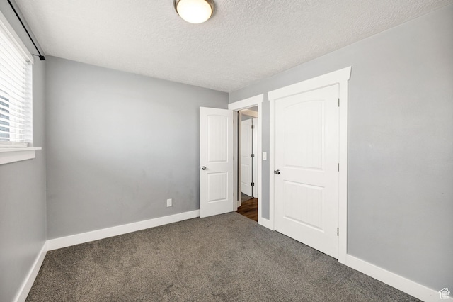 1170 N 730 E, Logan, UT 84341 - unfurnished bedroom with carpet, baseboards, and a textured ceiling