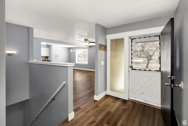 1170 N 730 E, Logan, UT 84341 - entryway featuring dark wood-type flooring, a ceiling fan, baseboards, and a textured ceiling