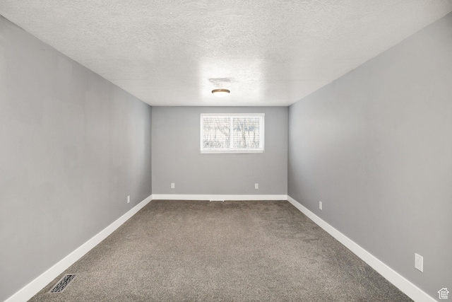 1170 N 730 E, Logan, UT 84341 - spare room with visible vents, baseboards, a textured ceiling, and dark carpet