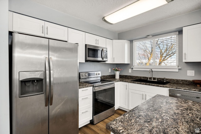 1170 N 730 E, Logan, UT 84341 - kitchen with appliances with stainless steel finishes, white cabinetry, and a sink