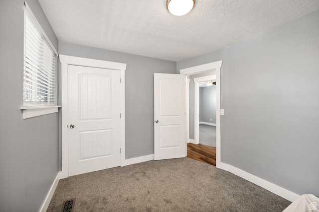 1170 N 730 E, Logan, UT 84341 - unfurnished bedroom with visible vents, baseboards, carpet, a closet, and a textured ceiling