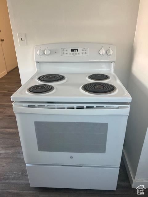 details featuring white electric range oven and dark wood-style floors