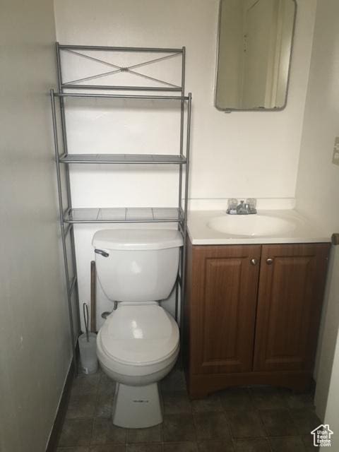 bathroom featuring toilet and vanity