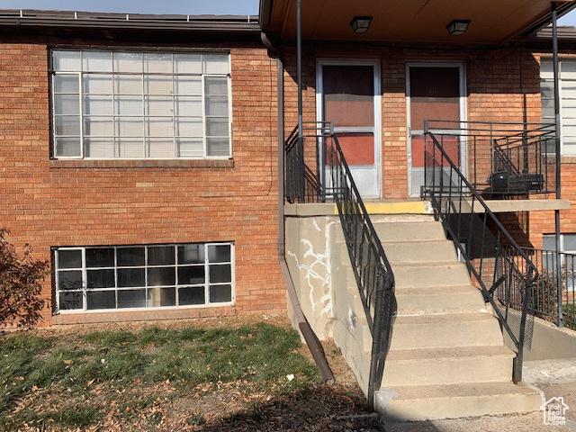 property entrance with brick siding