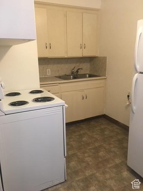 kitchen featuring decorative backsplash, white appliances, light countertops, and a sink