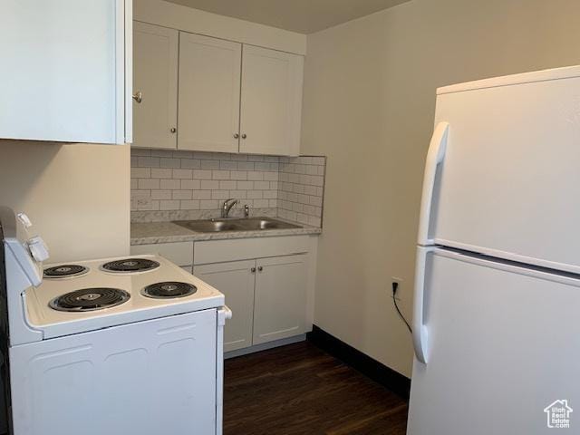 kitchen with tasteful backsplash, light countertops, dark wood-style floors, white appliances, and a sink