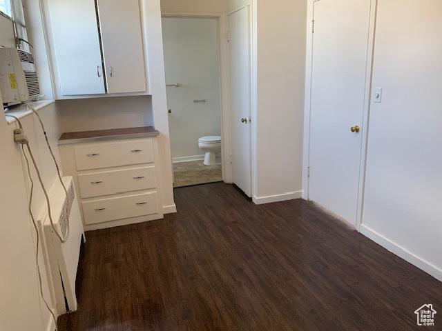 interior space featuring toilet, wood finished floors, and baseboards