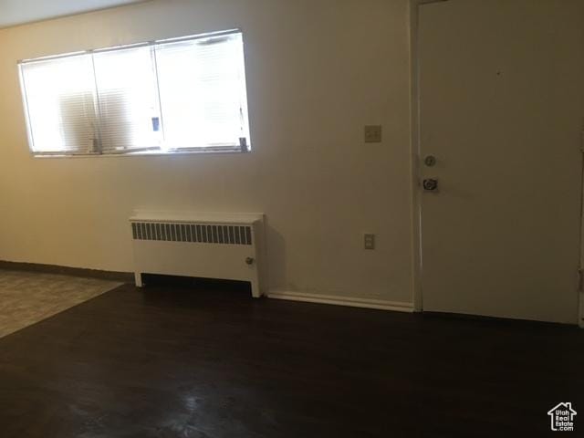 interior space with radiator and baseboards