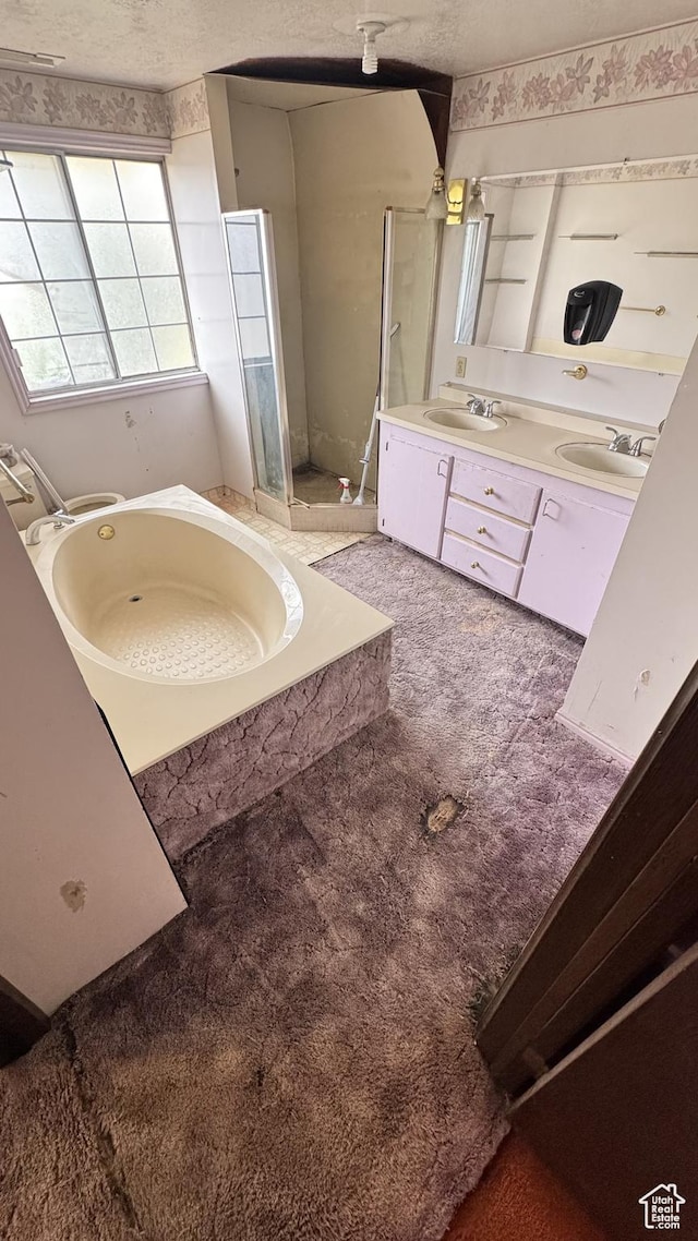 1010 Sullivan Rd, Ogden, UT 84403 - full bathroom with double vanity, a shower stall, a garden tub, and a sink