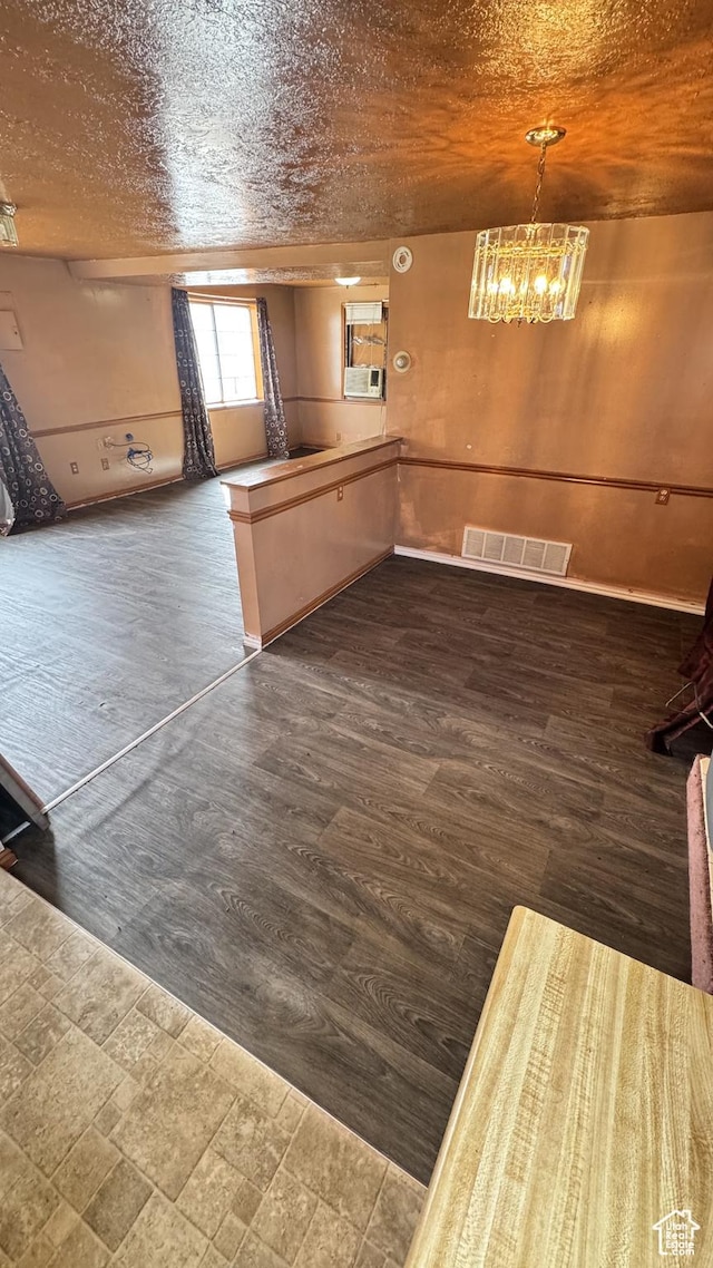 1010 Sullivan Rd, Ogden, UT 84403 - kitchen featuring visible vents, a peninsula, dark wood-style floors, a notable chandelier, and a textured ceiling