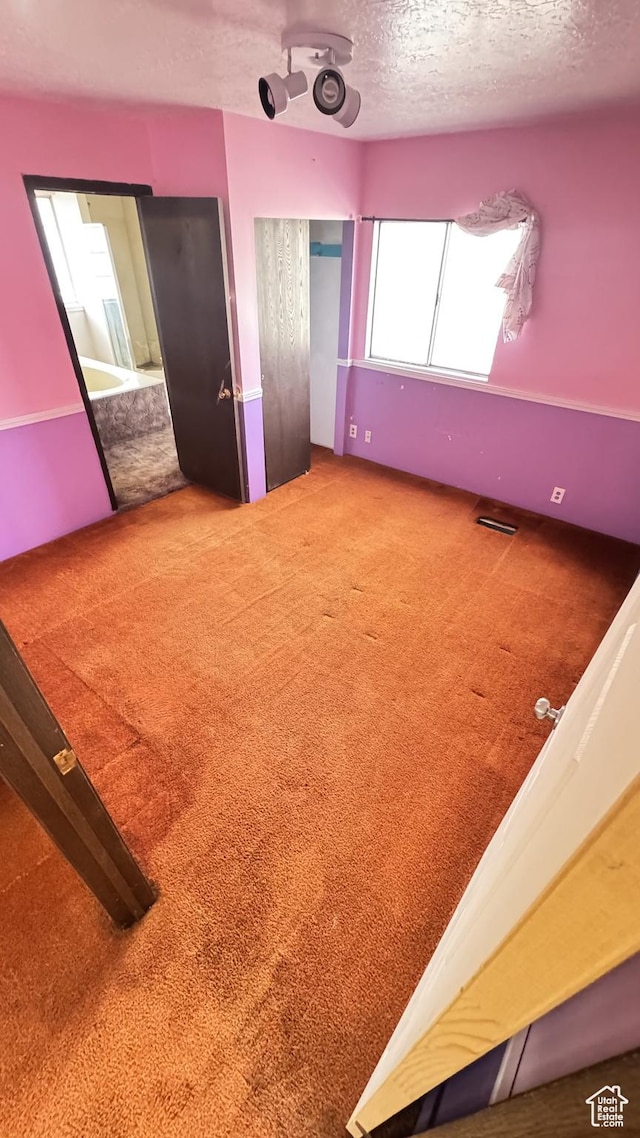 1010 Sullivan Rd, Ogden, UT 84403 - unfurnished bedroom featuring visible vents, carpet floors, and a textured ceiling