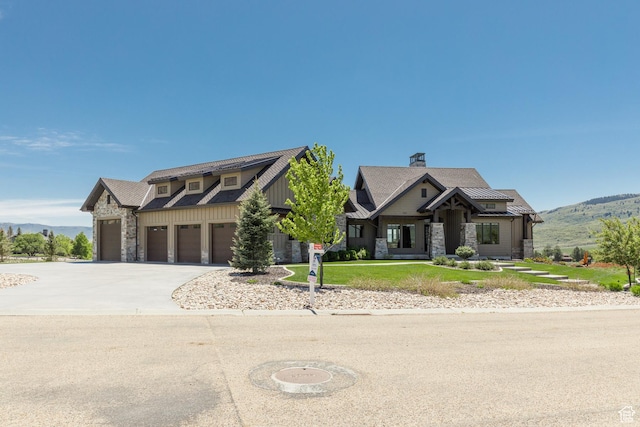 3651 N Eagle Ridge Dr E, Eden, UT 84310 - view of front of house featuring stone siding, a mountain view, driveway, and a garage