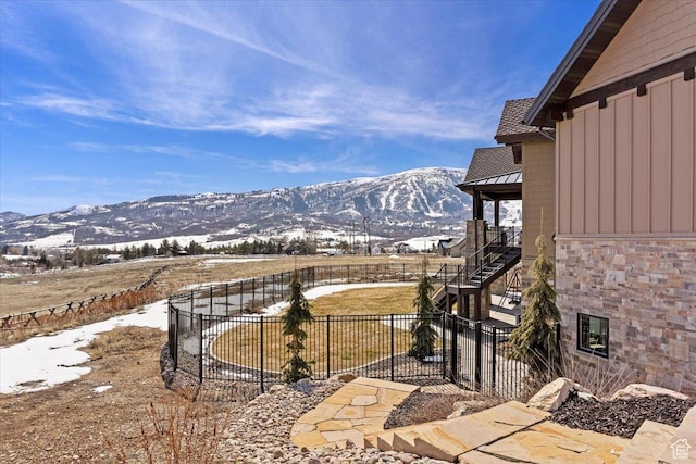 view of yard featuring stairs, fence private yard, and a mountain view