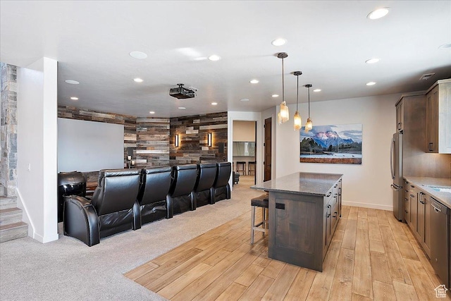 cinema featuring light carpet, recessed lighting, light wood-style floors, and baseboards