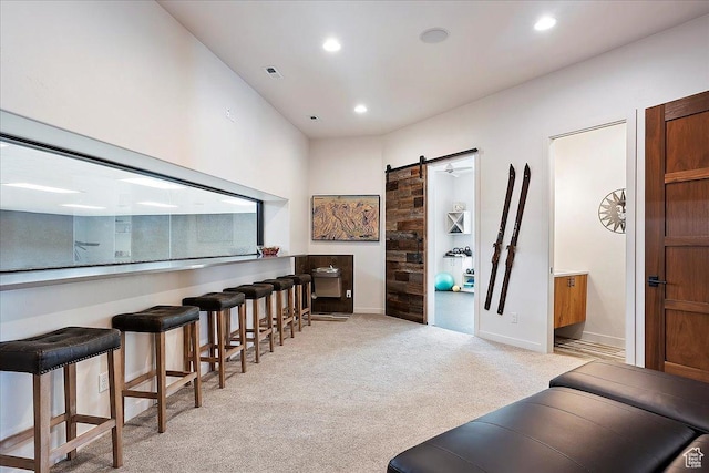 bar featuring visible vents, light carpet, recessed lighting, a barn door, and baseboards