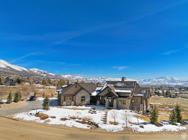 view of front of property with a mountain view and stone siding