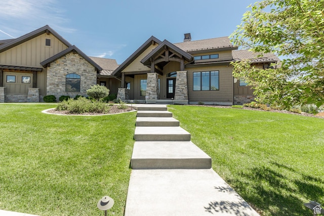 3651 N Eagle Ridge Dr E, Eden, UT 84310 - view of front of house featuring board and batten siding, a front lawn, a chimney, and stone siding
