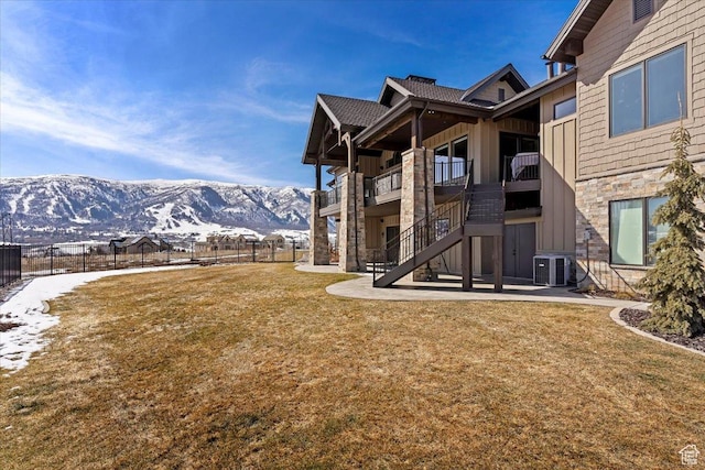 view of yard with a patio, stairway, fence, central air condition unit, and a mountain view