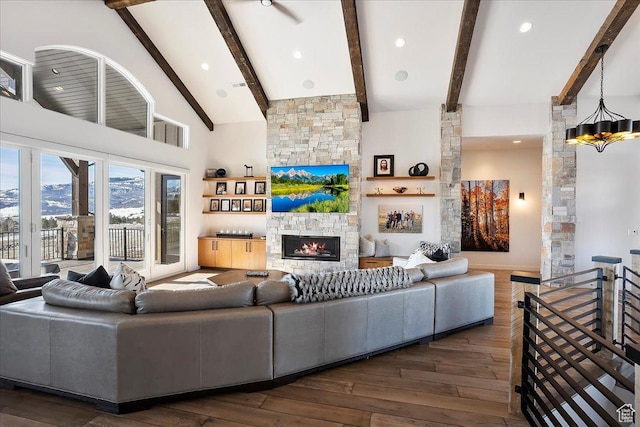 living area featuring visible vents, high vaulted ceiling, a fireplace, dark wood-style flooring, and beamed ceiling