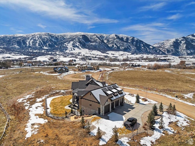 snowy aerial view with a mountain view