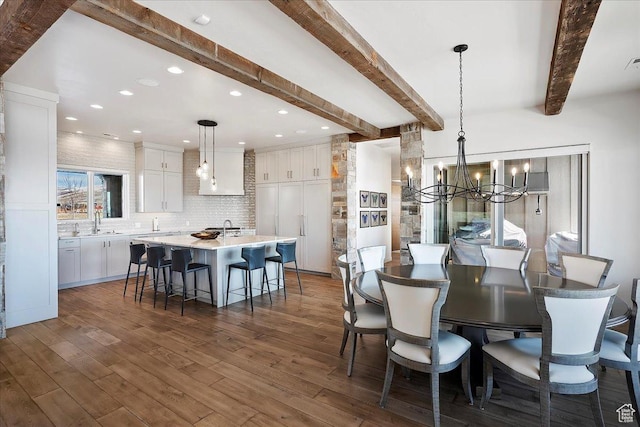 dining space featuring beam ceiling, recessed lighting, dark wood-style flooring, and a chandelier