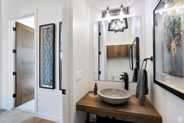 bathroom with vanity and wood finished floors