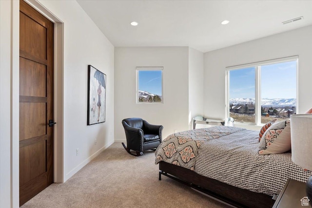 bedroom featuring recessed lighting, visible vents, light carpet, and baseboards