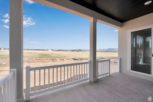 view of patio / terrace with a view of rural / pastoral area and a mountain view