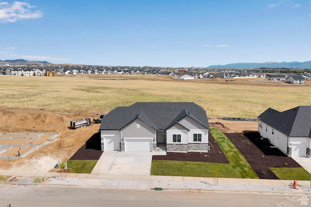 aerial view of property and surrounding area with a mountainous background