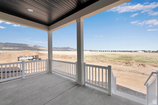 view of patio / terrace with a mountain view and a view of countryside