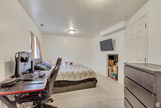 bedroom with light colored carpet, visible vents, and baseboards