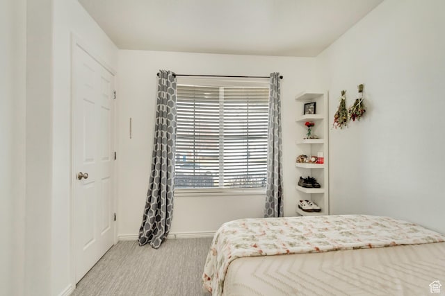 bedroom featuring carpet and baseboards