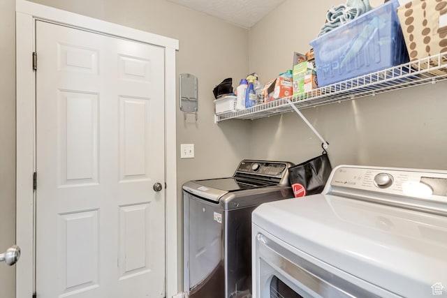 washroom with washing machine and dryer and laundry area
