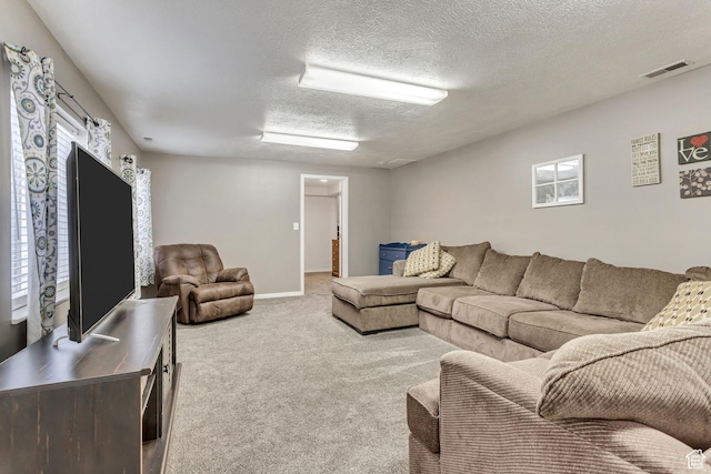 living room featuring visible vents, carpet flooring, a textured ceiling, and baseboards
