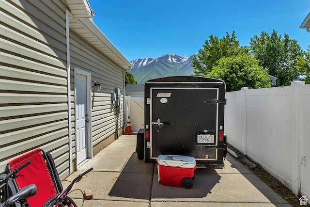 view of patio featuring a mountain view and fence