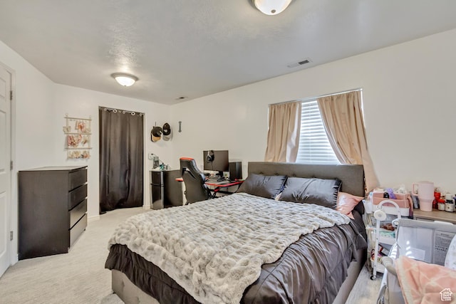 bedroom with light colored carpet and visible vents