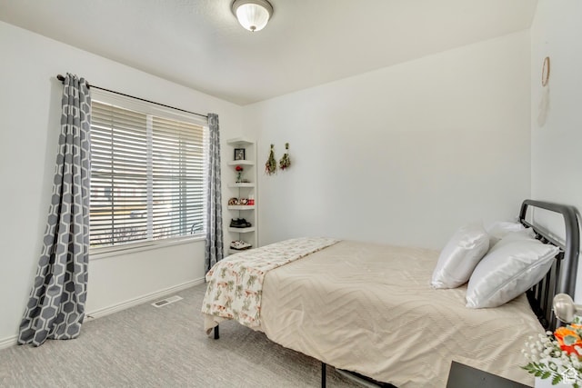 bedroom with baseboards, carpet floors, and visible vents